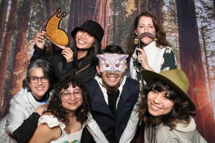 A group of people pose for a photo in a photobooth